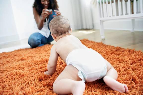 Baby crawling across freshly baby safe cleaned carpet