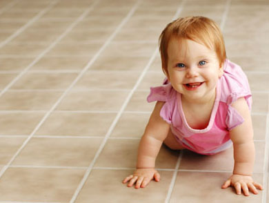 Baby crawling across freshly cleaned tile